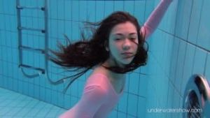 Roxalana Cheh wearing pink dress in the pool