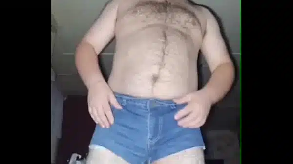 A fat-assed gay man masturbates his cock in ripped denim shorts and black stockings!