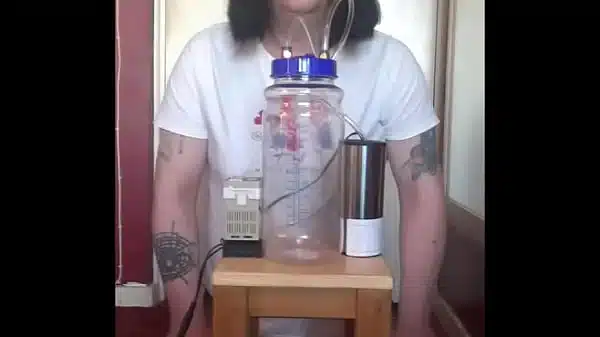 bisexual crossdresser with his portable cow milking machine