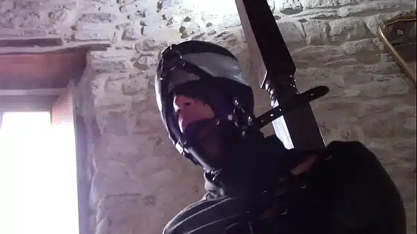 Laura XXX is tied up, masked with nylon and blindfolded. She has to deepthroat a cock without mercy